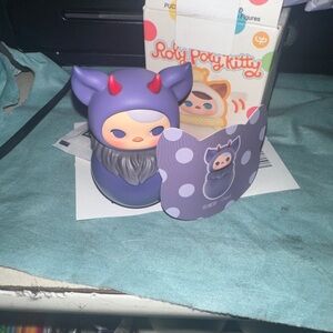 Purple and Gray Toy Figure with Horns